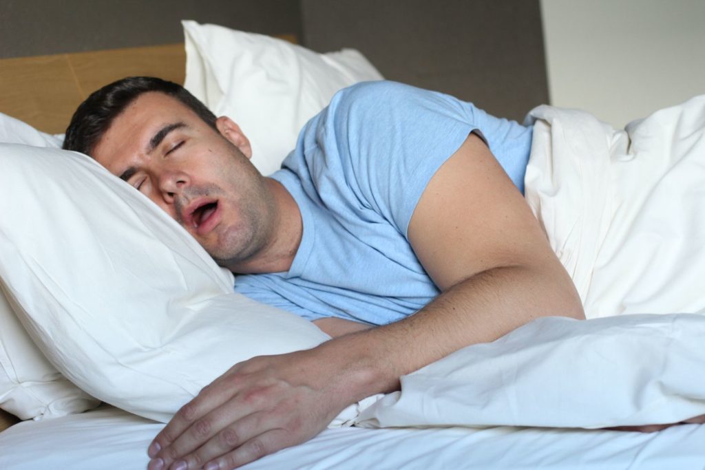 Man sleeping with mouth open and snoring sleep apnea dentist in Dallas Texas