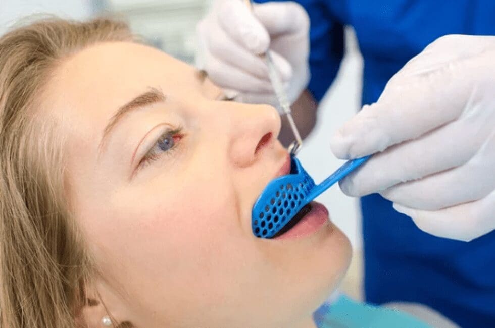 young woman getting fitted for custom mouthguard general dentistry dentist in Dallas Texas